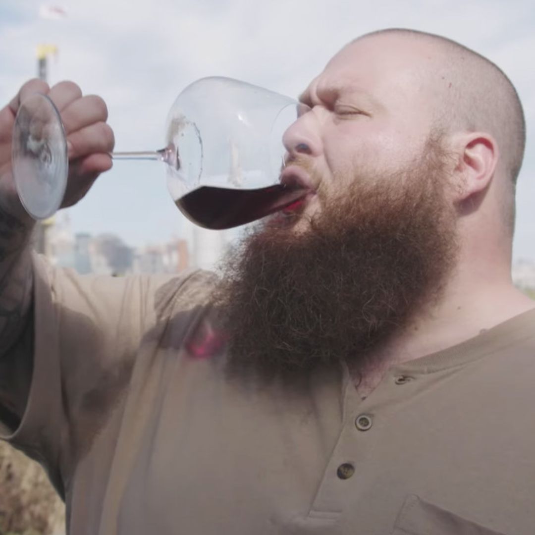 Action Bronson drinking a glass of red natural wine